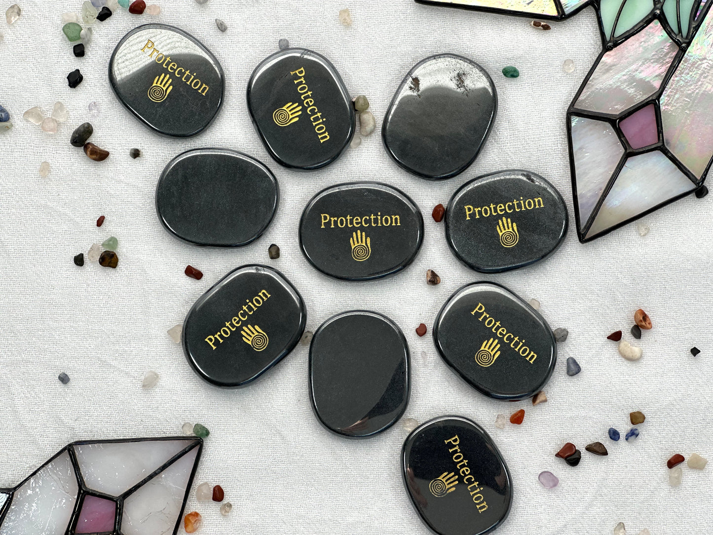 Flat hematite palm stone, with shaman hand printed along with the word protection in gold ink. Engraved in one side. Flat and smooth in both sides