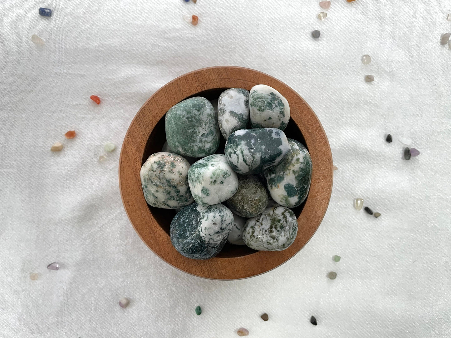 wooden bowl with rounded crystals of TRee Agate