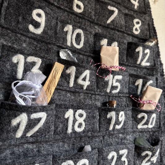 Felt fabric advent calendar with embroidered white numbers